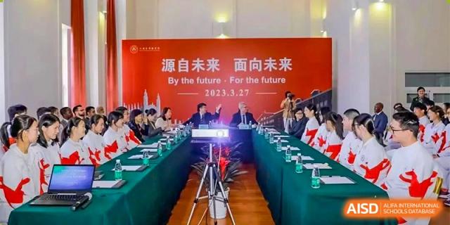 Students and staff from RCF Experimental School attending a meeting or conference in a large hall.