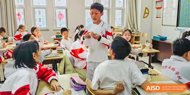 Students from RCF Experimental School laughing and talking together in a classroom.