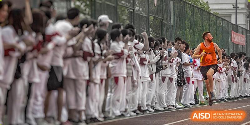 A large group of students from RCF Experimental School in uniform standing in formation, possibly for a school ceremony or parade.