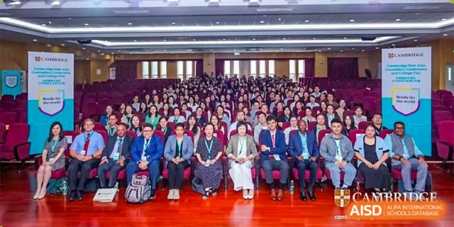 A large group of people, including students and adults, sitting and posing for a group photo at RCF Experimental School.