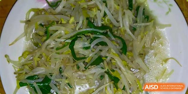 A dish of bean sprouts and other green vegetables from the cafeteria at RCF Experimental School.