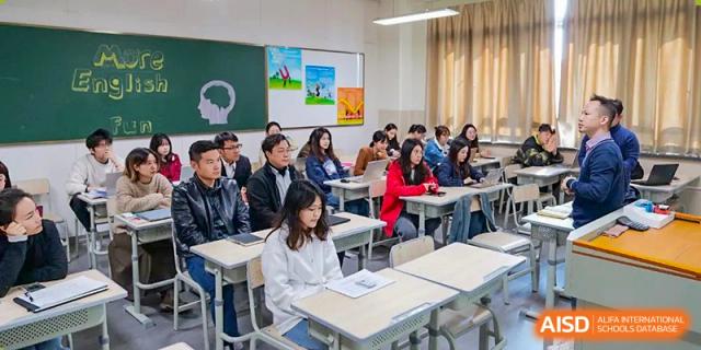 Students seated at individual desks, looking toward the front of the classroom during a lesson at Guangdong Experimental High School IFPAD & A-Level.