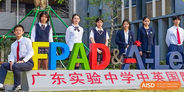 Students in uniform standing next to large, colorful "PAD" letters, representing the program at Guangdong Experimental High School IFPAD & A-Level.