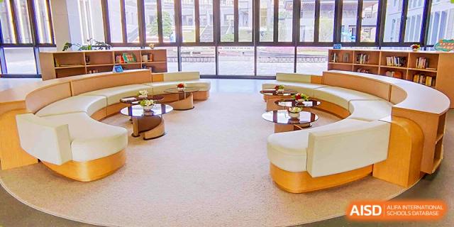 A bright, modern study or common area with comfortable seating and large windows at Guangdong Experimental High School IFPAD & A-Level.