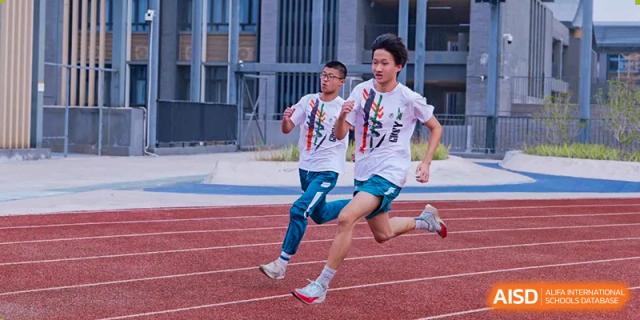Two students running in a race on a track, likely during a sports event at Guangdong Experimental High School IFPAD & A-Level.