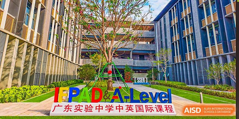 An exterior view of the school grounds featuring signage for the IFPAD & A-Level program at Guangdong Experimental High School.
