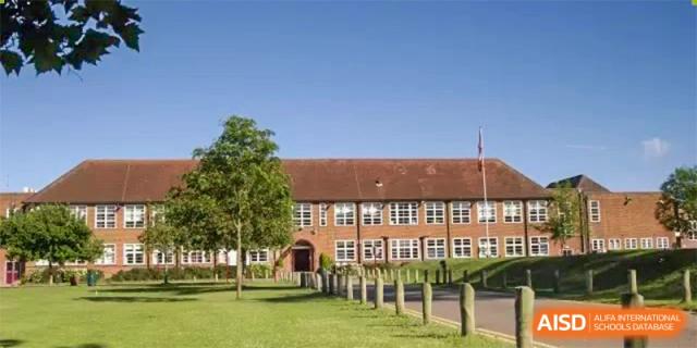 Exterior view of a traditional-style red brick school building and lawn on the campus of Guangdong Experimental High School IFPAD & A-Level.