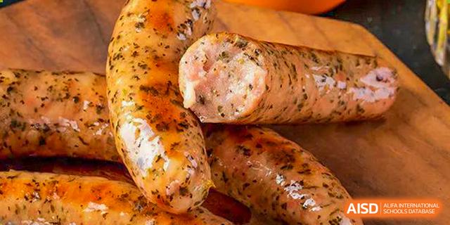 Close-up of baked or roasted sausage links in a serving tray, a protein option provided at Guangdong Experimental High School IFPAD & A-Level.