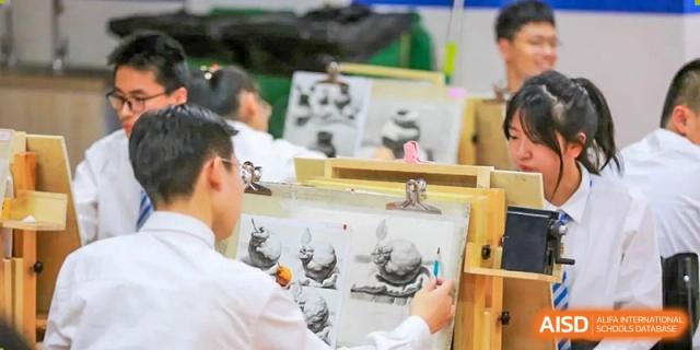 Students focus intently on their charcoal sketches during a professional fine arts or drawing class at Hefei High-tech Sino-Canadian School.