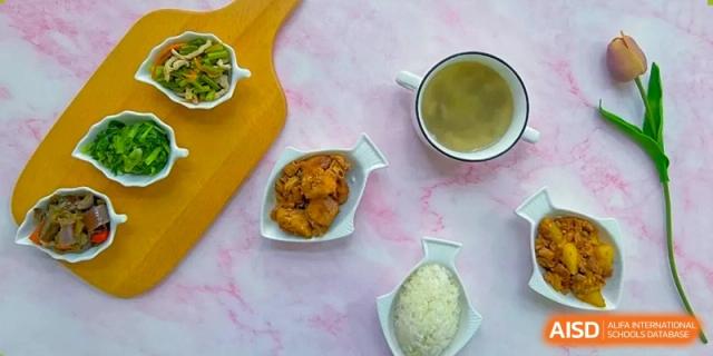 An overhead view shows a nutritious lunch set featuring chicken, rice, soup, and a side of vegetables at Hefei High-tech Sino-Canadian School.