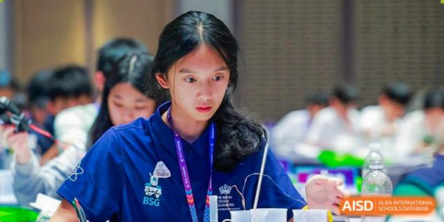 A female student from The British School of Guangzhou with intense focus, participating in a sports or physical activity.