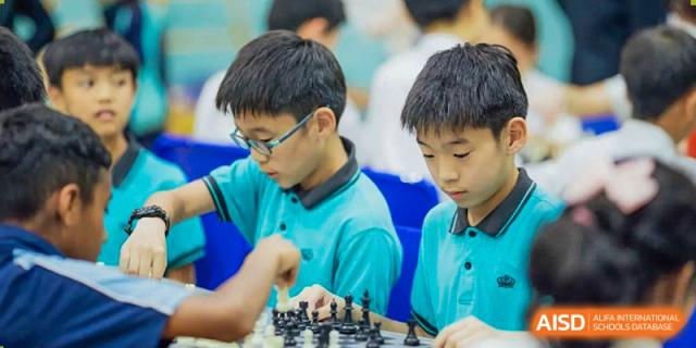 Two students from The British School of Guangzhou intensely focused on a game of chess during a club or competition.