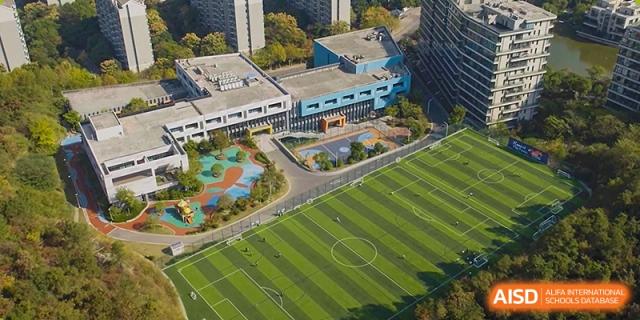 An aerial view of the sports field and buildings at The British School of Nanjing.