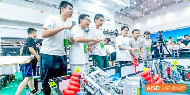 Students from The High School Affiliated To Beijing Normal University working on a robotics project in a classroom or lab.