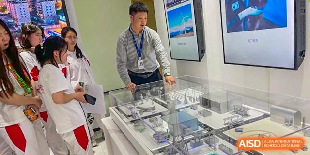 A male student from The High School Affiliated to Renmin University of China, Tongzhou Campus, presents a project to a teacher.