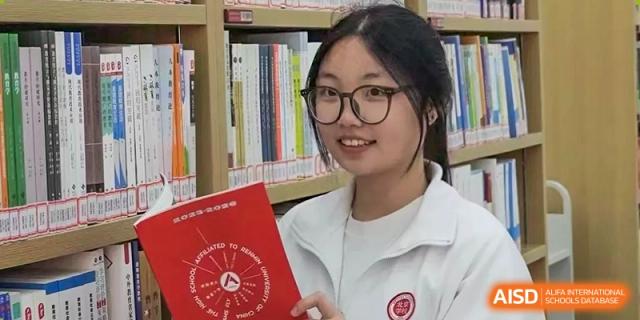 A female student from The High School Affiliated to Renmin University of China, Tongzhou Campus, sits and reads a book in a library.