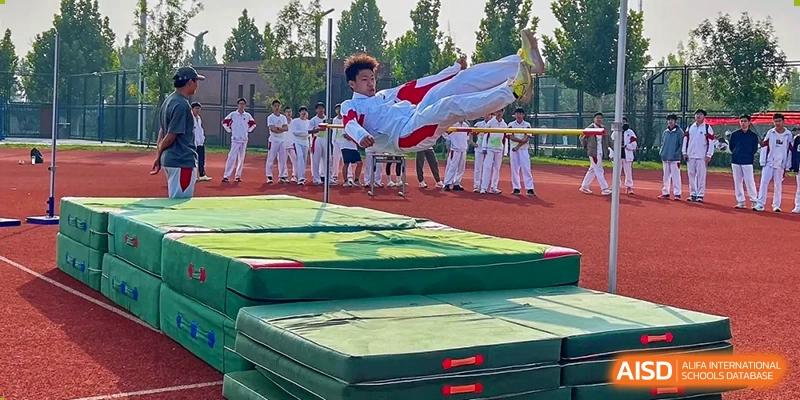 A student from The High School Affiliated to Renmin University of China, Tongzhou Campus, performs a high kick during a martial arts demonstration.