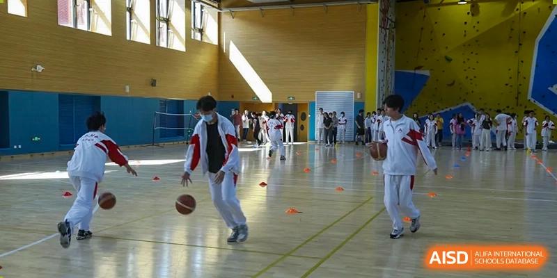 Students from The High School Affiliated to Renmin University of China, Tongzhou Campus, participate in a basketball drill.