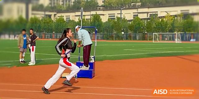 Students from The High School Affiliated to Renmin University of China, Tongzhou Campus, participate in a sports activity on a track.
