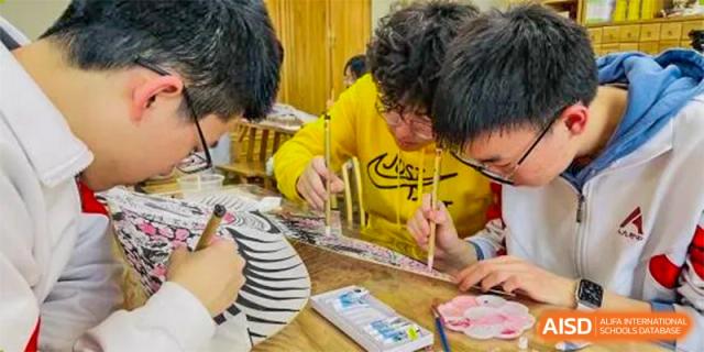 Students from The High School Affiliated to Renmin University of China, Tongzhou Campus, work on a project with colorful paper and tape.