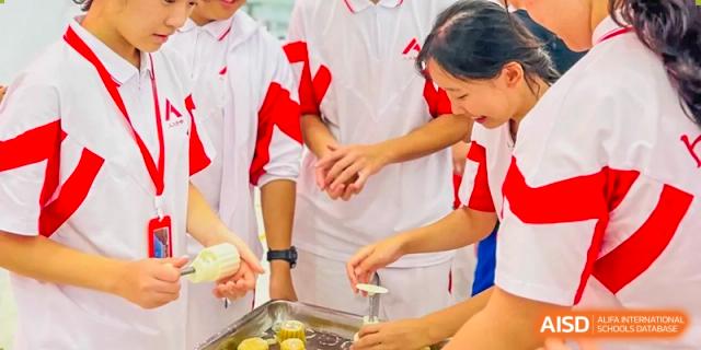 A teacher from The High School Affiliated to Renmin University of China, Tongzhou Campus, helps a student prepare food.