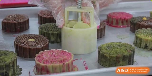A variety of finished mooncakes with different colors and shapes, created by students from The High School Affiliated to Renmin University of China, Tongzhou Campus.