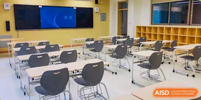 An empty classroom at Tianfu school The Integrated and Innovative Curriculum with chairs and desks arranged for a class.