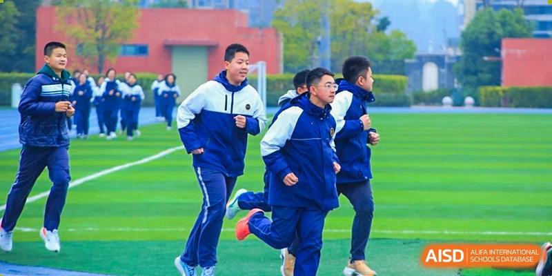 Students from Tianfu school The Integrated and Innovative Curriculum running on a sports field.
