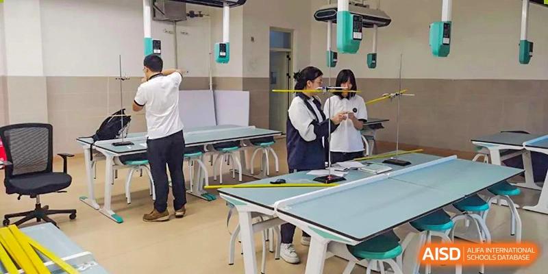 Students from Tianfu school The Integrated and Innovative Curriculum working on a project with tables and equipment.