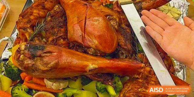 A large roasted meat dish with vegetables, possibly a school meal at Tianfu school The Integrated and Innovative Curriculum.