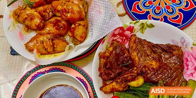 A close-up of a roasted meat and potato dish, possibly from the Tianfu school The Integrated and Innovative Curriculum cafeteria.