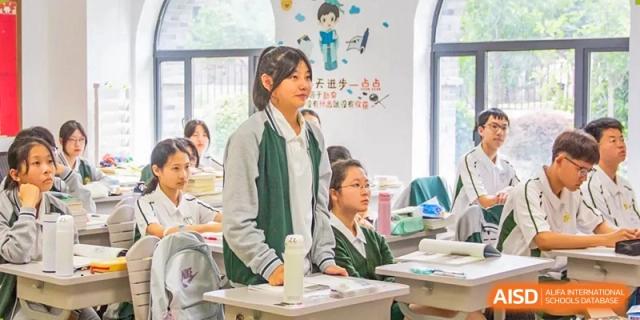 Students from Times College paying close attention in a classroom setting.