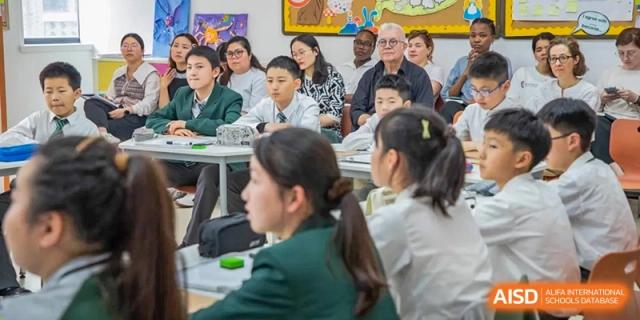 Students from Times College sitting at desks, listening to a lesson.