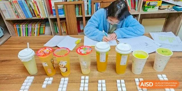 A table with drinks and what appears to be sugar cubes, representing a health and nutrition lesson at Times College.