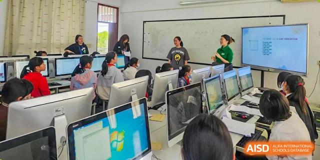 UWC Changshu China students working at computers in a classroom.