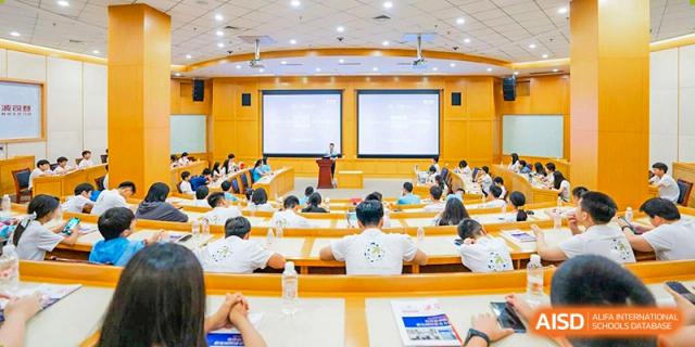 A UWC Changshu China lecture hall filled with students and a teacher at the front.
