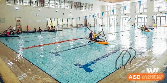 A UWC Changshu China student in a kayak in the school swimming pool.