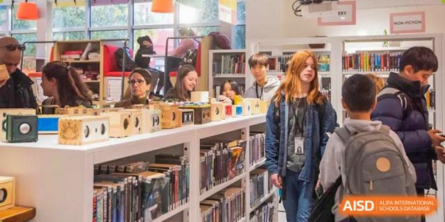 Western Academy of Beijing students browse for books on the shelves of a school library.