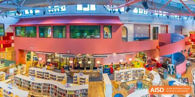 An open-plan view of a vibrant, colorful Western Academy of Beijing school library.