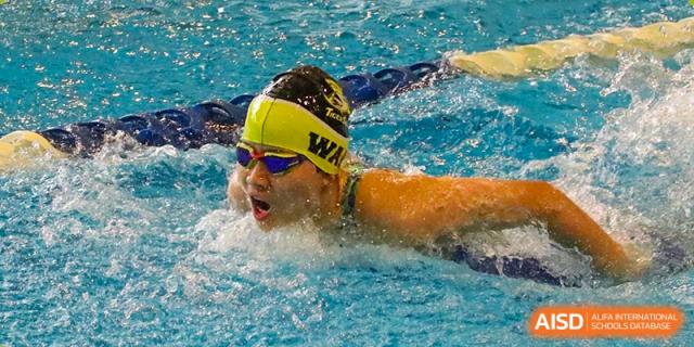Two Western Academy of Beijing students swimming laps in a competition.