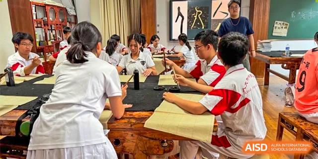 Students wearing white and red uniforms are seen learning to sew in a classroom at the Xishan School of The High School Affiliated to Renmin University of China.