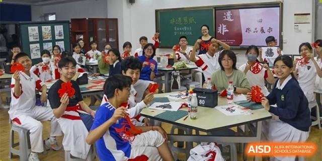 A group of students is seated at desks in a classroom, with a teacher standing at the front at the Xishan School of The High School Affiliated to Renmin University of China.