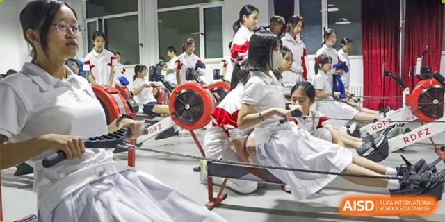 A close-up of Xishan School of The High School Affiliated to Renmin University of China students using indoor rowing machines.