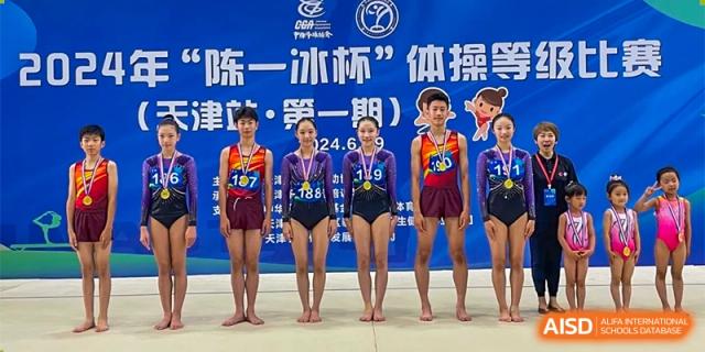 Xishan School of The High School Affiliated to Renmin University of China students on a podium with medals at a competition.