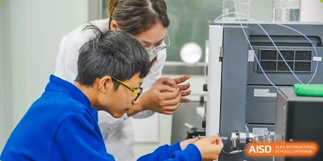 A teacher helps a student with a hands-on activity at Yew Wah International Education School Of Beijing Yizhuang Campus.