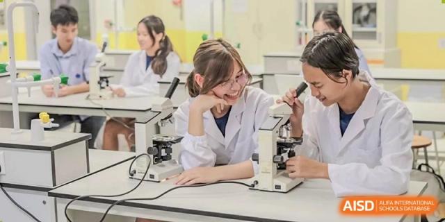 Female students at Yew Wah International Education School Of Beijing Yizhuang Campus use microscopes.
