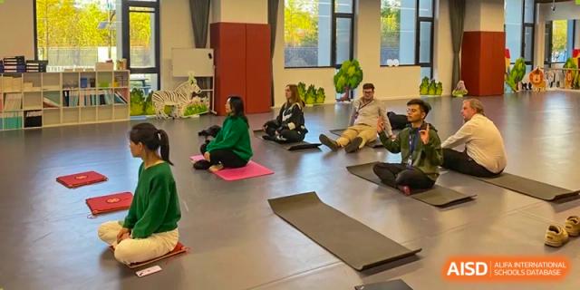 Yew Wah International Education School Of Beijing Yizhuang Campus students participating in a yoga activity.