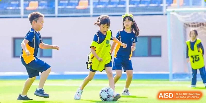Yew Wah International Education School Of Beijing Yizhuang Campus students playing soccer.