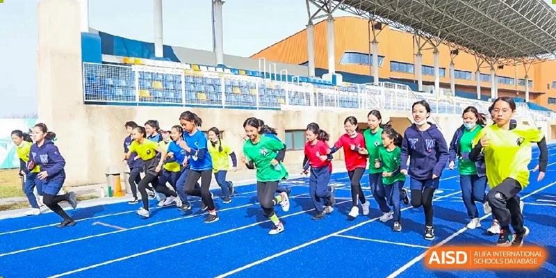 Yew Wah International Education School Of Beijing Yizhuang Campus students participate in a track and field activity.