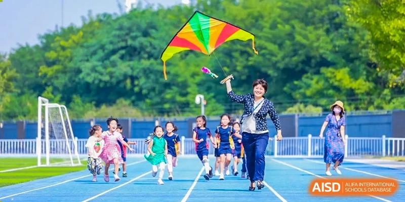Yew Wah International Education School Of Beijing Yizhuang Campus students fly kites.